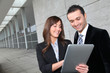 Business people meeting outside with electronic tablet