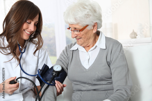 Photo: Closeup of nurse checking senior woman blood pressure Closeup of nurse checking senior woman blood pressure