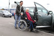 Young man assisting senior woman in wheelchair