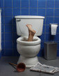 Foot reaches up through the seat from out of a toilet. Foot reaches up through the seat from out of a toilet.