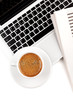 Cappuccino cup on laptop. Above view Cappuccino cup on laptop. Above view