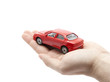 Hand holding a small red car. Clipping path included.