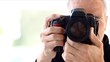 senior professional  photographer shooting with his camera