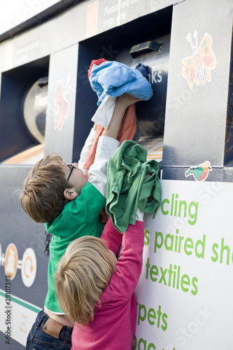 Photo: Two young children recycling clothes Two young children recycling clothes