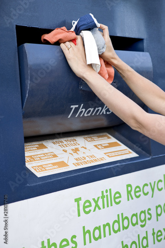 Photo: A mid-adult woman recycling clothes A mid-adult woman recycling clothes