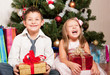 girl and boy near a fir-tree
