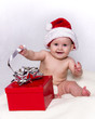 Baby in Santa Hat Playing with Christmas Gift Baby in Santa Hat Playing with Christmas Gift