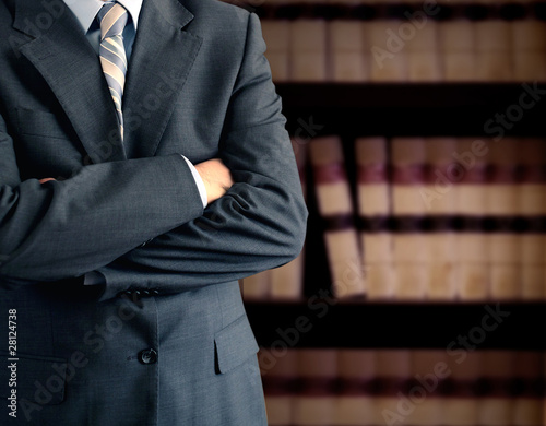Photo: Businessman in front of books Businessman in front of books