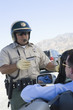 Highway patrol officer examines man's driving license