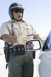 Highway patrol officer examines driving license
