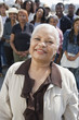 Woman standing near crowd, portrait