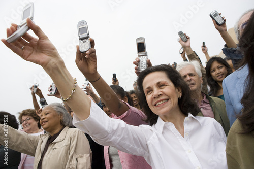 Photo: Crowd holding up mobile phones Crowd holding up mobile phones