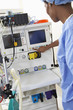 Female surgeon operating medical equipment