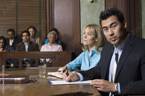 Photo: Defense lawyer with client in court Defense lawyer with client in court