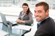 Happy businesspeople working together on a laptop