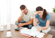 Worried couple doing their accounts in the living room