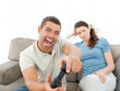 Pretty woman waiting for her boyfriend playing video games