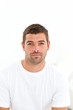Portrait of a serious man sitting on his bed