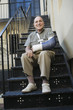 Man with broken arm sitting on stairs
