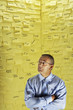 Photo: Middle-aged man in glasses, standing in front of wall covered in sticky notes Middle-aged man in glasses, standing in front of wall covered in sticky notes
