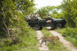Leopard Panthera pardus crossing road, tourists in jeep in background