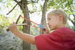 Boy 7-9 using slingshot