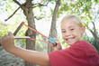 Boy 7-9 using slingshot