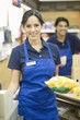 Supermarket employee in blue apron