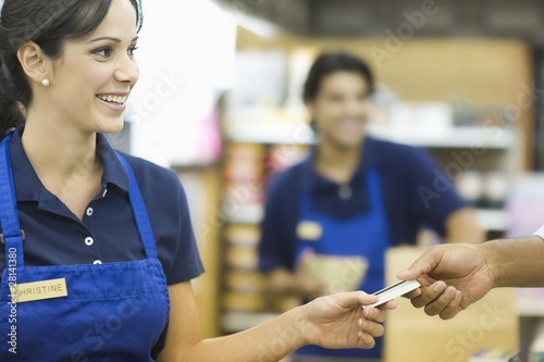 Photo: Supermarket employee in blue apron Supermarket employee in blue apron
