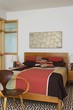 Patchwork quilt on bed in Autumn colours