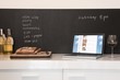 Chalkboard list with cut bread and laptop computer