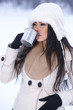 Beautiful holding mug in snowy winter outdoors