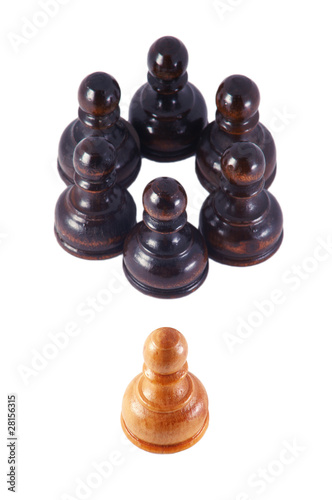Photo: White pawn isolated from a group of black pawns , on white White pawn isolated from a group of black pawns , on white