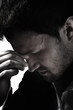 Foto: A young man that has an intense headache. A young man that has an intense headache.