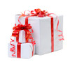 A white box tied with a red satin ribbon bow. A gift for Christm A white box tied with a red satin ribbon bow. A gift for Christm