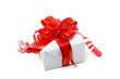 A white box tied with a red satin ribbon bow. A gift for Christm A white box tied with a red satin ribbon bow. A gift for Christm