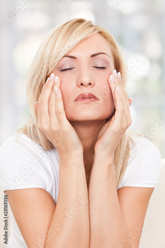 Photo: Beauty woman massaging her face Beauty woman massaging her face