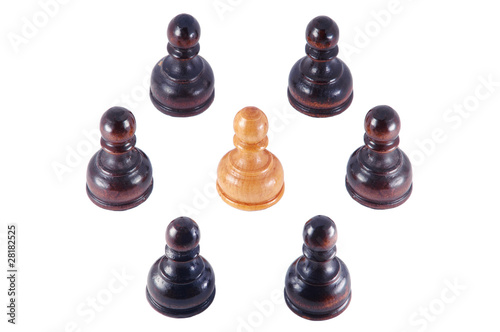Photo: Pawn surrounded by a group of black pawns , isolated on white Pawn surrounded by a group of black pawns , isolated on white