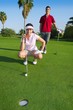 young golf woman looking and aiming the hole young golf woman looking and aiming the hole