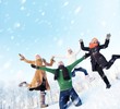 Happy friends jumping in the snow