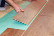 worker installing new laminate flooring