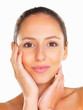 Sultry woman with hands on face