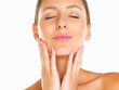 Relaxed woman with hands on face and eyes closed