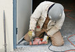 Worker Drilling Door Jam