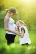 Photo: Girl listening to pregnant mother's belly Girl listening to pregnant mother's belly