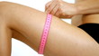 Close up of woman measuring her leg