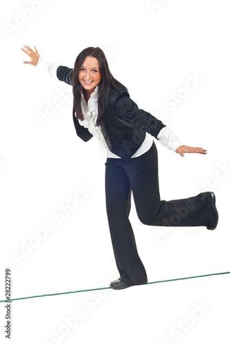 Photo: Business woman walk on tightrope Business woman walk on tightrope