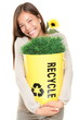 Woman holding recycling bin smiling Woman holding recycling bin smiling