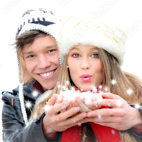 Photo: fantasy happy winter couple blowing a christmas wish fantasy happy winter couple blowing a christmas wish