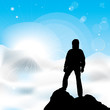 A silhouette of man staying on a top of a mountain and sun rays